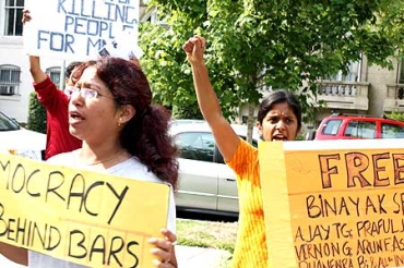 Protesters hold placards during a protest demanding the release of Dr Binayak Sen