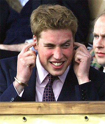 Prince William reacts to the loud music at a pop concert