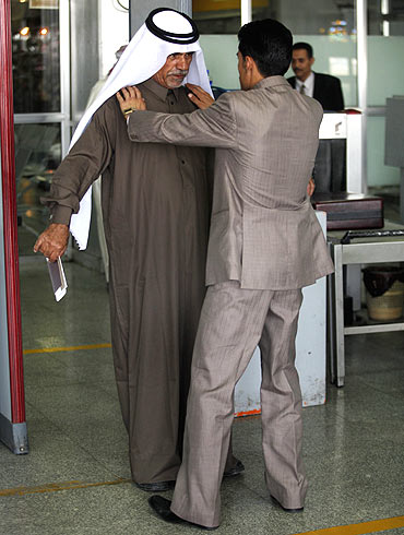 A security officer checks a passenger at the departure lounge of Sanaa International Airport in Yemen