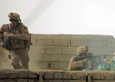 A US Marine from Bravo Company of the 1st Battalion, 6th Marines runs during a heavy gun battle in the town of Marjah, in Nad Ali district of Helmand province