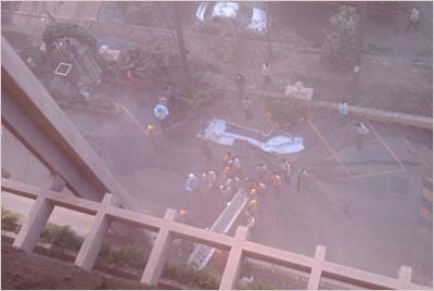 Firemen gather below the Carlton Towers