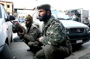 Policemen take position during the fidyaeen attack, at Lal Chowk in Srinagar