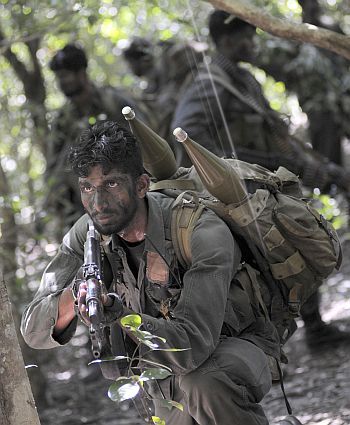 A Sri Lankan soldier keeps watch during a patrol in the jungle in the Puthukkudiyirippu area