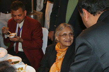 the Delhi CM interacts with a guests while having dinner