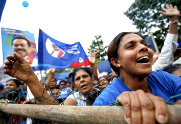 Supporters of President Mahinda Rajapakse cheer during a political rally