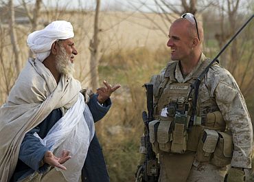 US Marine Corps Capt Scott A Cuomo, commander of Fox Company, Second Battalion, Second Marine Regiment, speaks with an Afghan villager in Garmsir district, Helmand province, Afghanistan