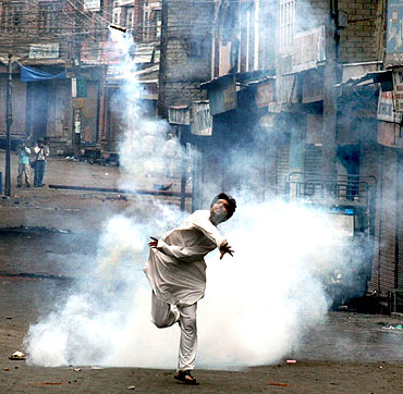 A protestor throws a crude bomb towards security forces in Srinagar