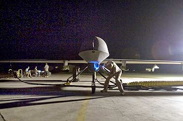 A US commander performs a pre-flight inspection of an MQ-1B Predator unmanned  drone