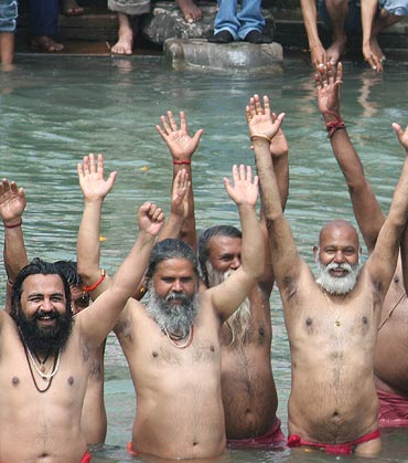 Sadhus rejoice after taking a dip in the Ganga