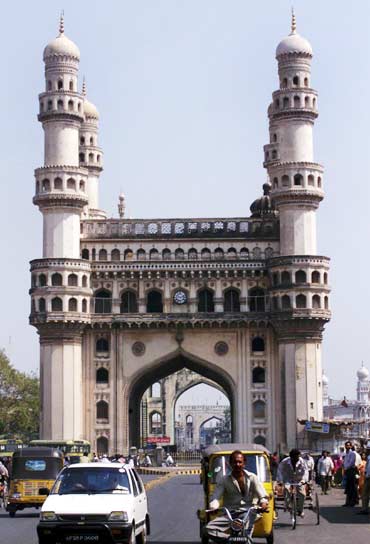 Residents of Hyderabad drive past Charminar