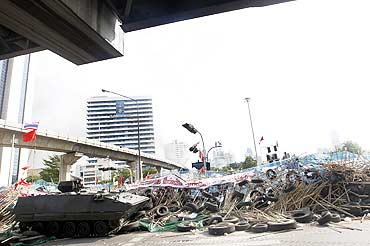 An armoured vehicle moves over the protestors' barricade