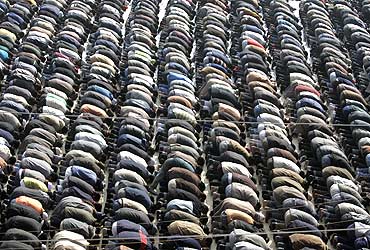 Muslim men perform special prayers outside a mosque