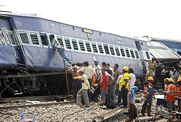 Rescue workers gather near the wreckage of the train