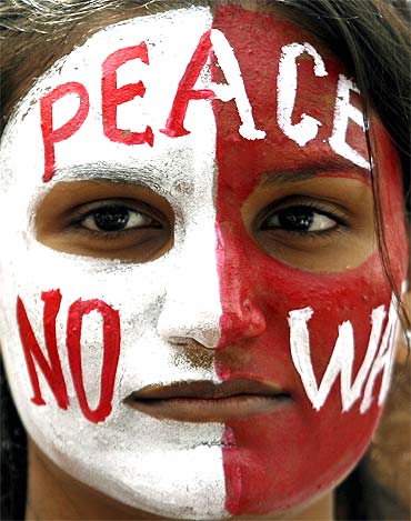 A student with a peace message painted on her face attends an anti-nuclear demonstration rally