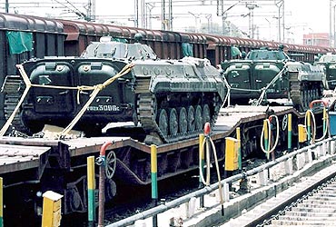 Indian tanks sit on train carriages, waiting to be dispatched to Kashmir