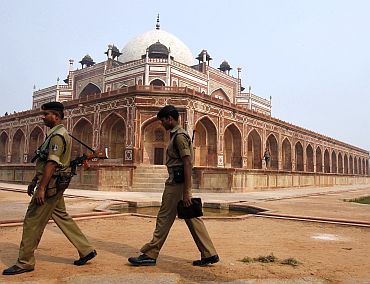 Security personnel keep watch inside the lawns of Humayun's Tomb in New Delhi