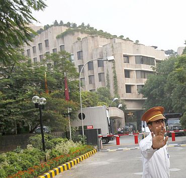 A hotel security guard stops the media outside the Hotel Maurya Sheraton