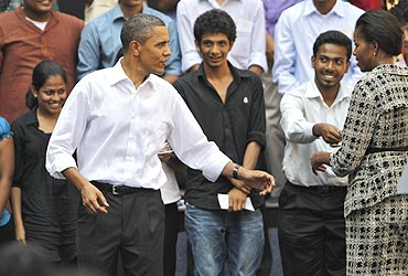 President Obama and first lady Michelle Obama greet students at a town hall meeting at a Mumbai college