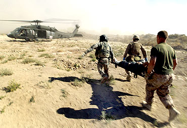 US Marines carry an injured Afghan national to a helicopter during a mission in southern Afghanistan's Helmand province