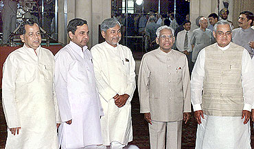 Former Prime Minister Vajpayee and President K R Narayanan chat with new ministers (L-R) Arjun Sethi, B K Tripathi and Nitish Kumar in 1998