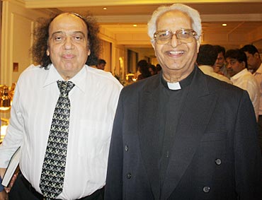 Solomon Sopher (left) and Fr Anthony D'Souza (right) attend the function