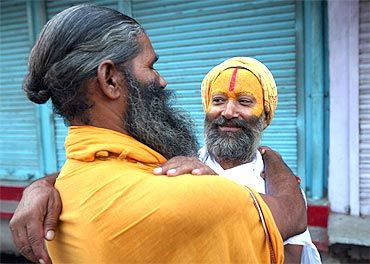 Sadhus hug each other to celebrate the Ayodhya verdict