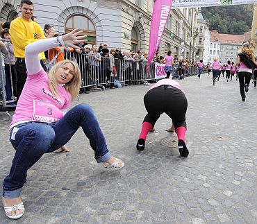 Participants pick themselves up after falling in a high heels race organised by a woman's magazine in Ljubljana's old city centre on October 2. Twenty contestants competed in the race, which is in its fourth year running, wearing heels at least 8 cm (3.15 inch) high