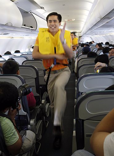 Cebu Pacific airlines cabin crew dance during a safety demonstration routine with the tune of 'Safety Dance' on a domestic flight to Davao city, southern Philippines. Cebu Air received some well-timed publicity this week when a video of its flight attendants dancing a safety demonstration routine racked up more than 6 million hits in five days after it was posted on the Internet. Airline representatives said they want to make their flights fun and help passengers pay attention to the demonstration