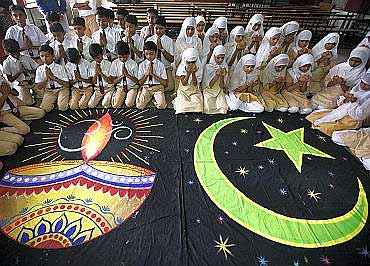 Hindu and Muslim school children offer prayers for peace in their school in Ahmedabad