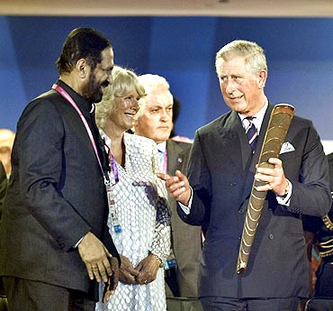 Suresh Kalmadi interacts with Britain's Prince Charles and Duchess of Cornwall Camilla Parker Bowles during the opening ceremony of the Games amid boos from the packed crowd at the Jawaharlal Nehru Stadium