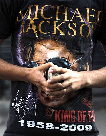 A Kashmiri protester, wearing a Michael Jackson t-shirt, holds a stone during an anti-India protest in Srinagar
