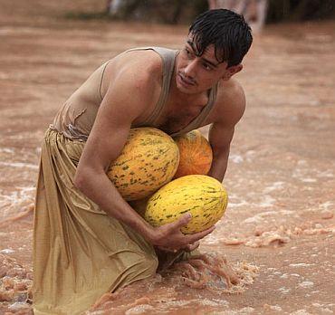 A victim makes his way in the floods