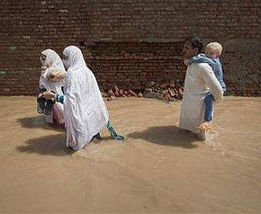 A family leaves its flooded home behind