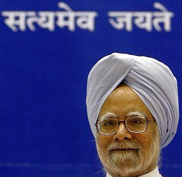 Dr Singh speaks at a New Delhi event. The sign behind reads 'Truth Alone Triumphs'