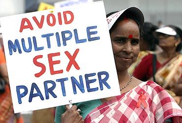 A HIV-positive woman holds a placard during an awareness rally