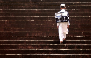 A young boy climbs the stairs of his school in Bhopal