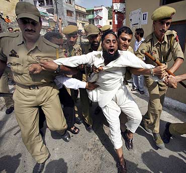 Police detain a demonstrator as he shouts slogans during a protest in Srinagar