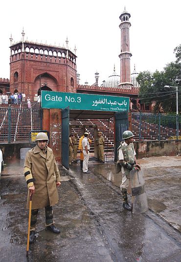 Police stand guard at the Jama Masjid after Sunday's shooting