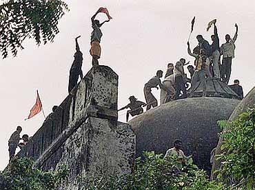 'Kar Sevaks' stand atop the demolished Babri Masjid