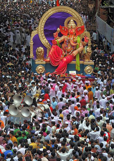 Devotees carry a Ganesh idol to immerse it in the waters of the Arabian Sea