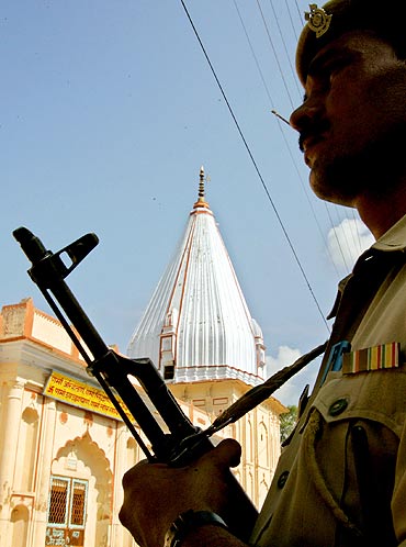 A policeman stands guard outside a temple in Ayodhya
