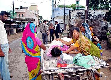 An ailing woman is taken away on curfew day, September 4