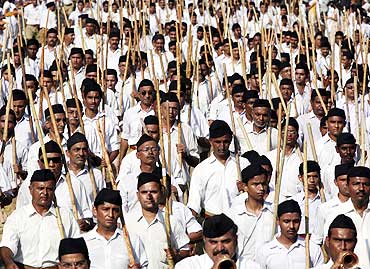 RSS members march march with their bamboo sticks during a festival