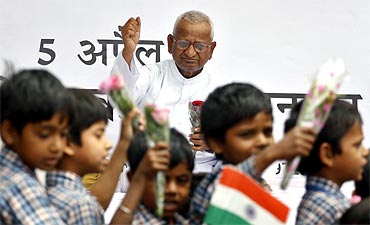 School children participate in a rally showing support to Hazare