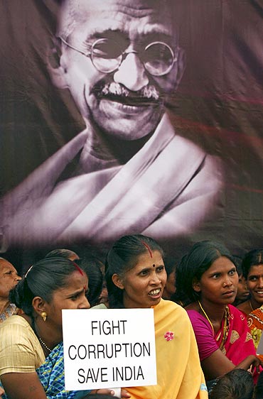 Supporters of Anna Hazare hold placards during a protest against corruption in Hyderabad