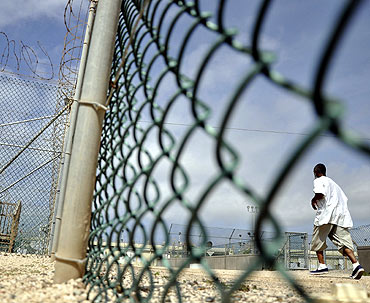 A detainee runs inside an exercise area at the detention facility at Guantanamo Bay