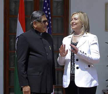 US Secretary of State Clinton speaks with Foreign Minister S M Krishna during a photo call before their meeting in New Delhi