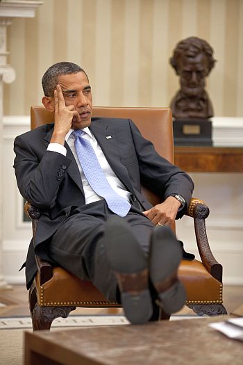 President Barack Obama listens during a meeting with advisors in the Oval Office