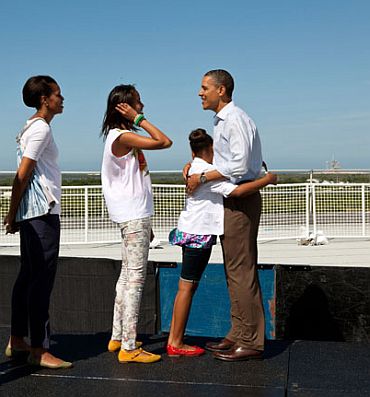 President Barack Obama, First Lady Michelle Obama and daughters Sasha and Malia stand on the viewing platform where they would have watched the launch of the Space Shuttle Endeavor at the Kennedy Space Center in Cape Canaveral