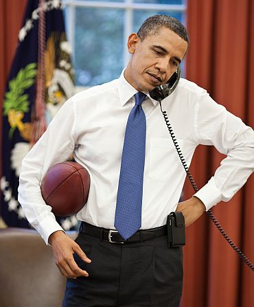 President Barack Obama talks on the phone with House Speaker John Boehner in the Oval Office
